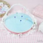 Old CD pincushion on pink gingham fabric