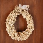 Book page wreath hanging on wooden wall