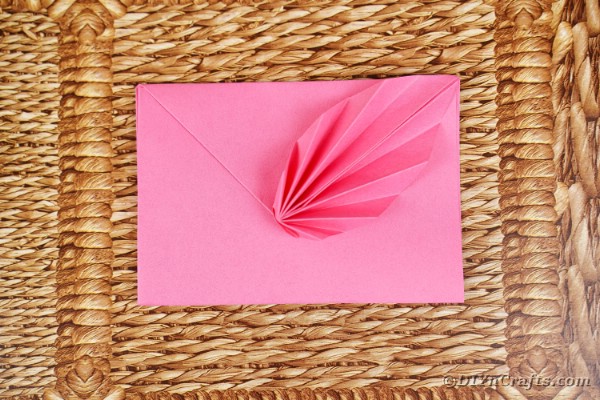 Origami envelope on woven mat