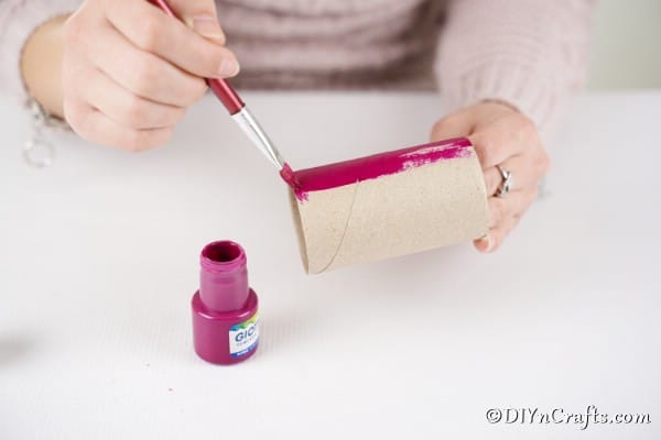 Painting toilet paper roll pink