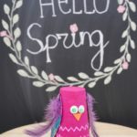 Plastic cup owl in front of chalkboard