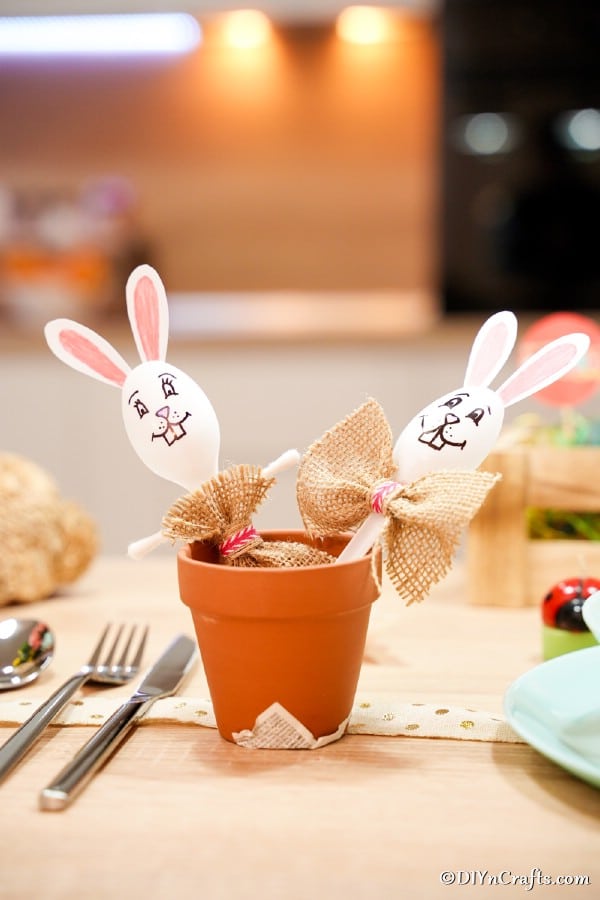 plastic spoon bunnies in a flower pot on table
