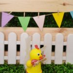 Chicken planter craft in front of white fence