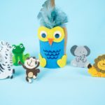 Wine glass owl surrounded by toy animals