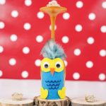 Wine glass owl in front of red polka dot background