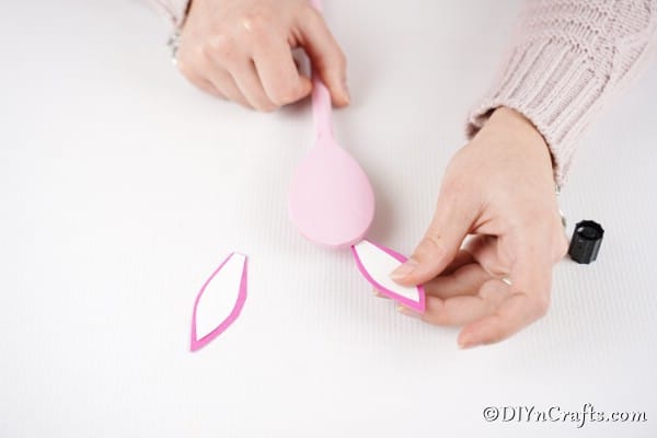 Gluing ears to pink spoon