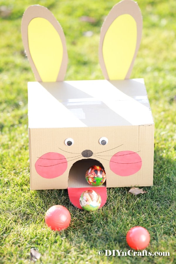 Cardboard bunny ball toss game on grass