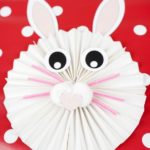 Paper bunny on red and white polka dot background