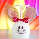 Easter bunny wine glass in front of colorful background