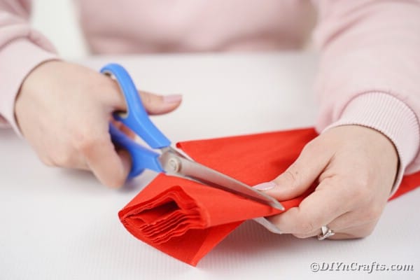 Cutting red tissue paper
