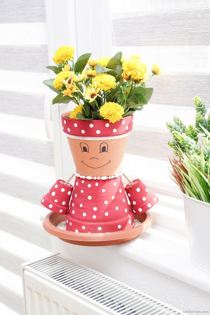 Pink polka dot flower pot in windowsill