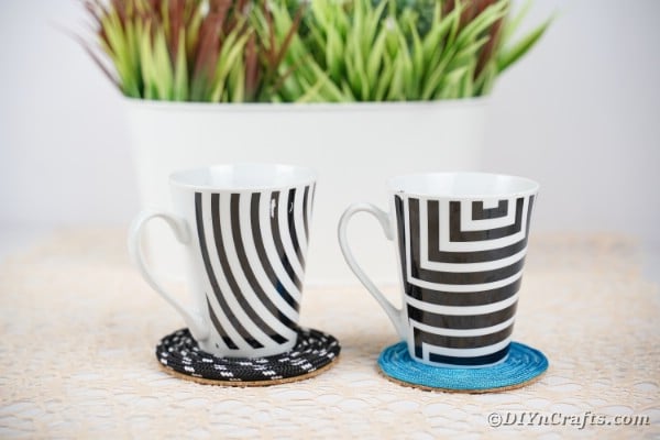 Black and white and blue coaster on table by potted plant