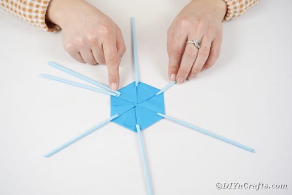 Gluing paper straw to base