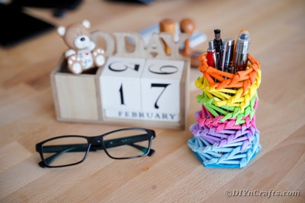 Rainbow pencil holder on desk by block calendar