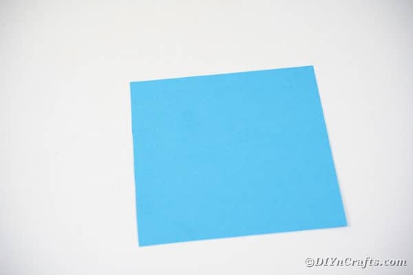 Square of blue paper on table