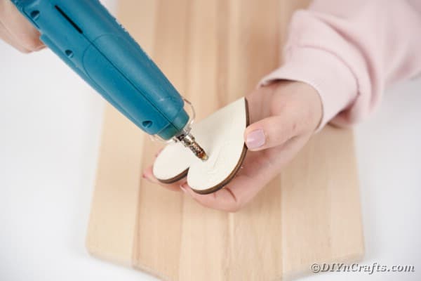 Glue wooden heart to cutting board