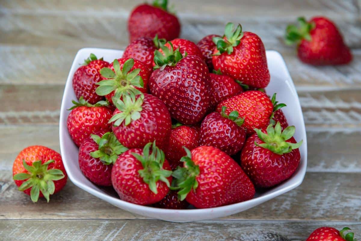 A bowl full of ripe, juicy strawberries.