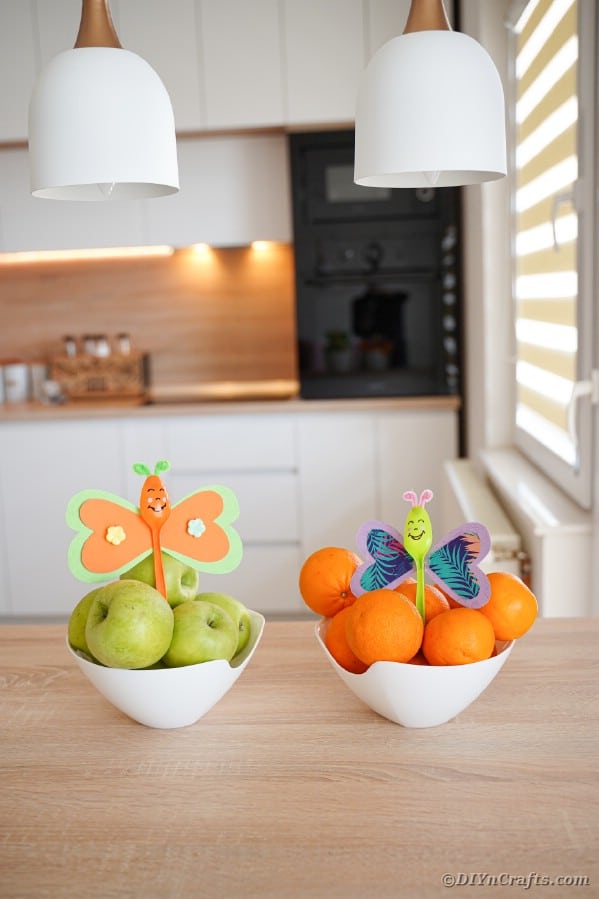 Butterfly spoons in bowls of fruit
