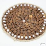 Coffee bean coaster on white surface
