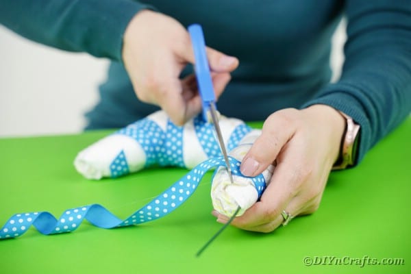 Tying ribbon onto a diaper hook