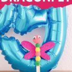 Dragonflly in front of blue balloon