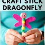 Women in teal shirt holding dragonfly craft