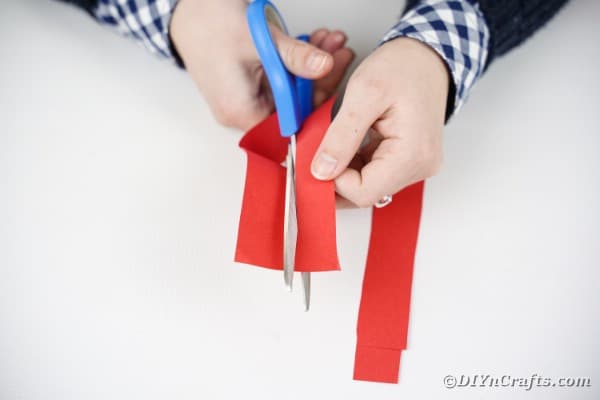 Cutting strips of red paper