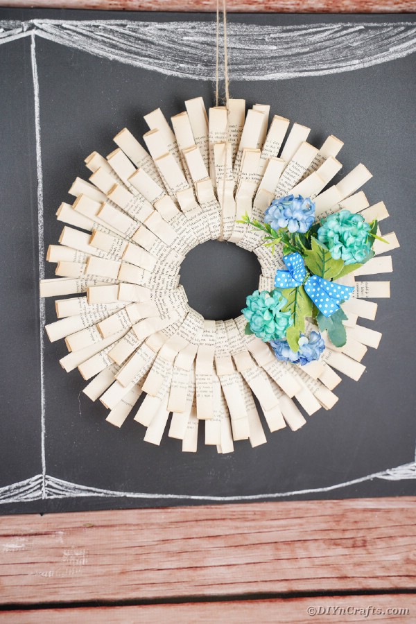 Paper wreath hanging on chalkboard