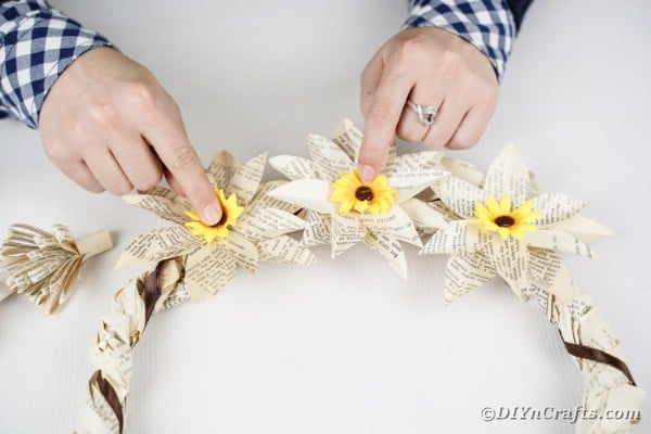 Attaching sunflowers to wreath