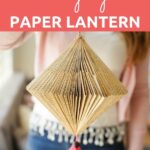 Woman holding paper lantern with pink tassel