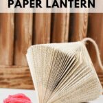 Paper lantern hanging against wodoen slats