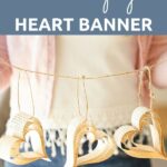 Woman holding paper heart banner