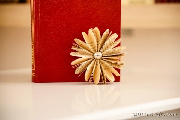 Old book page flower against red book