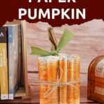 Paper pumpkin by wooden background