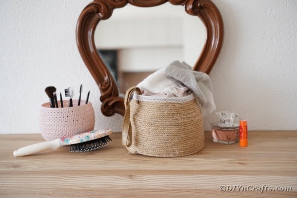 Rope basket on table with makeup brushes