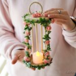 Woman holding birdcage candle holder