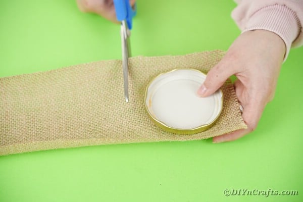 Cutting a square of burlap