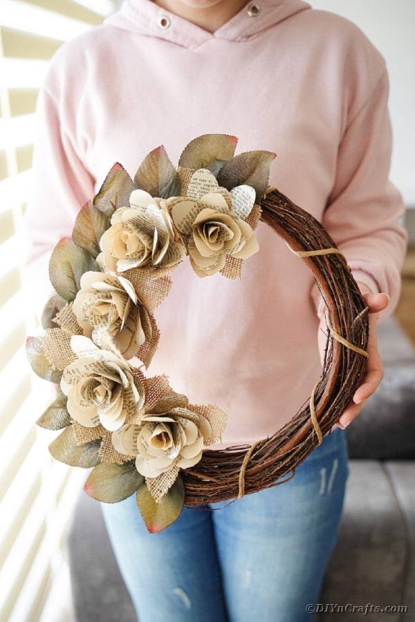 Burlap rose wreath held by woman