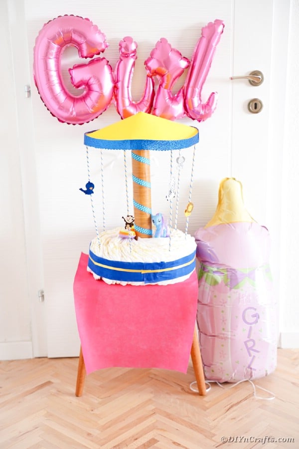 Carousel diaper cake on pink table