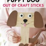 Woman holding a craft stick dog