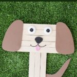 Craft stick puppy on grass
