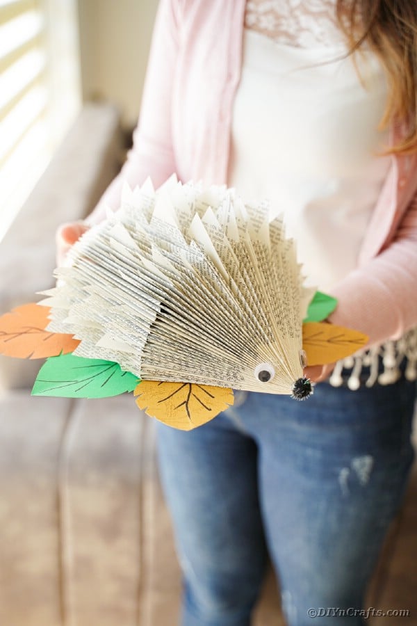 Woman holding paper hedgehog