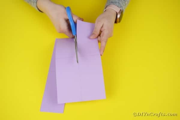 Cutting purple paper