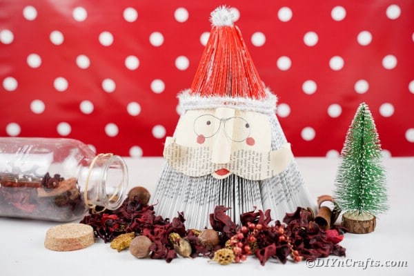 Book Santa Claus in front of red polka dot background