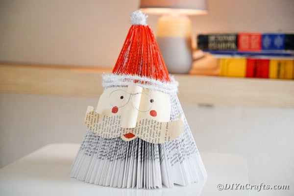 Old book santa Claus on table in front of lamp