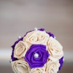 Purple and cream tissue paper ball on table