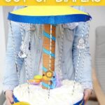 Woman holding carousel diaper cake