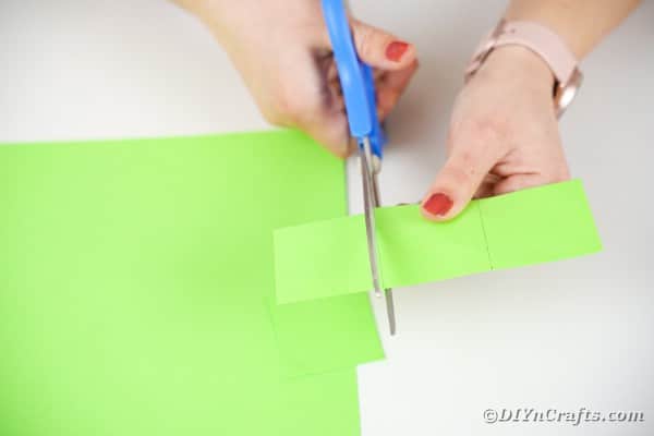 Cutting green paper