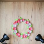 Flower wreath on wood wall with lights