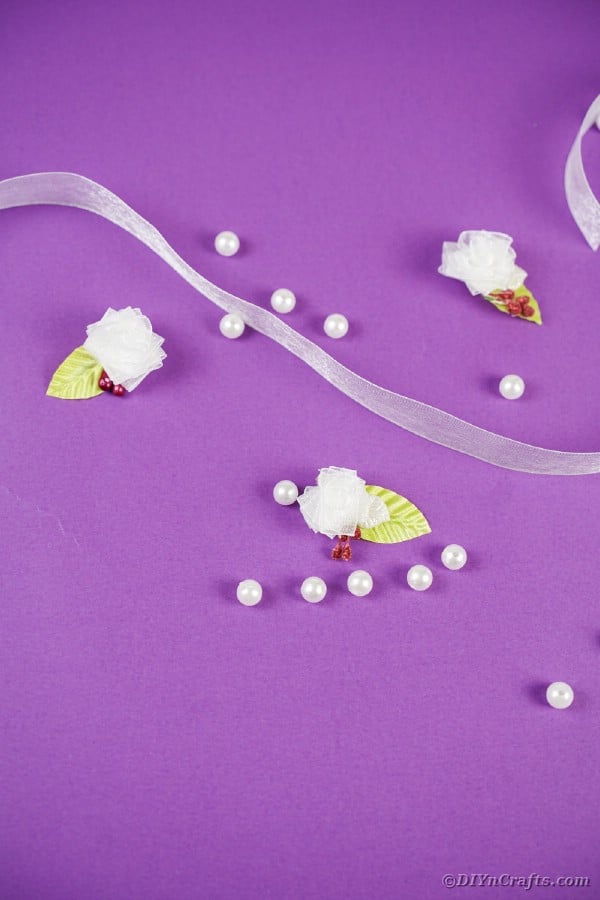 Miniature ribbon flowers on purple surface